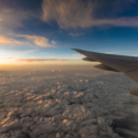 an airplane wing above the clouds