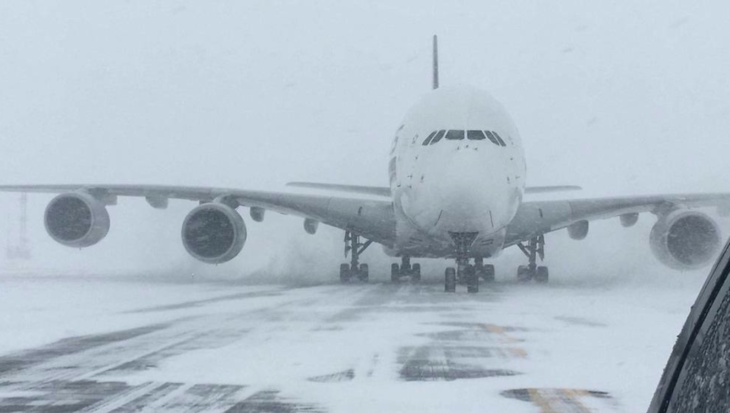 a plane on a runway in the snow