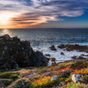 a rocky coastline with a sunset