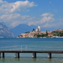 a dock over water with buildings in the background