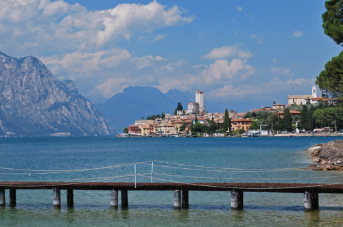 a dock over water with buildings in the background