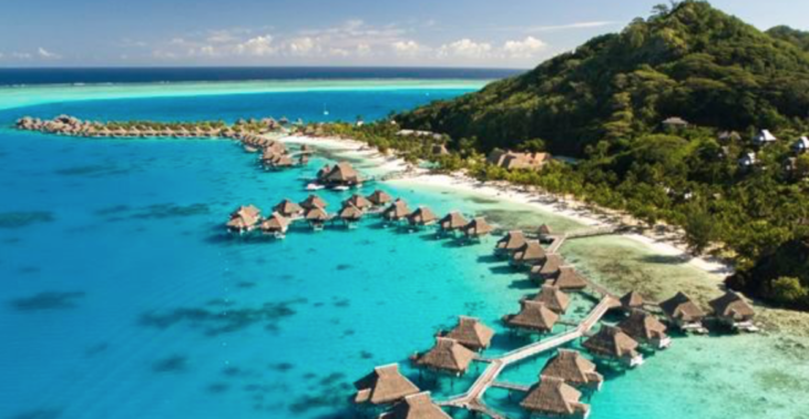 a group of huts on water