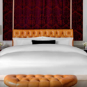 a bed with a leather headboard