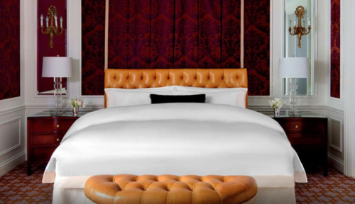 a bed with a leather headboard