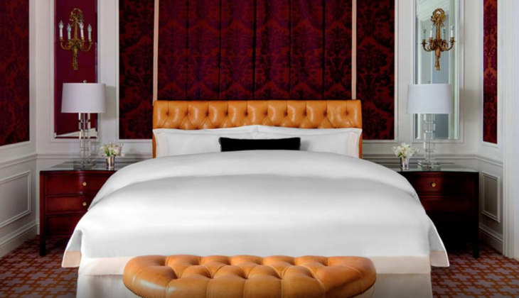 a bed with a leather headboard