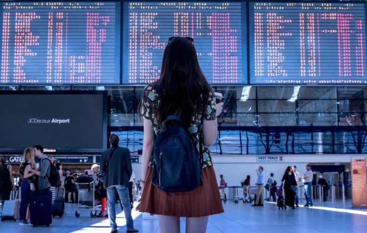 a woman looking at a board