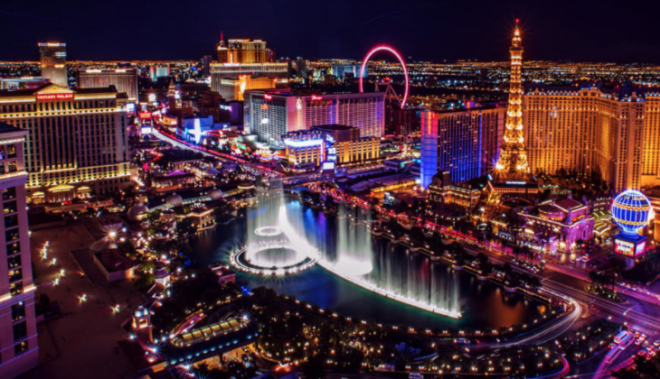 a city with a fountain and a ferris wheel