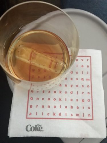 a glass of liquid on a napkin