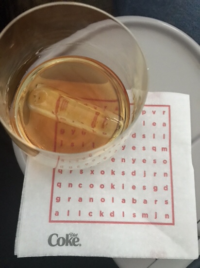 a glass of liquid on a napkin