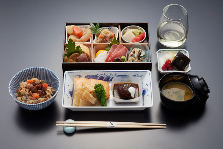 a tray of food and chopsticks