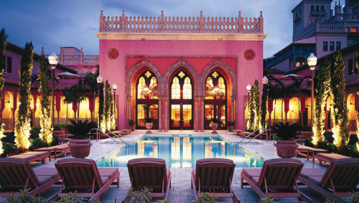 a pink building with a pool