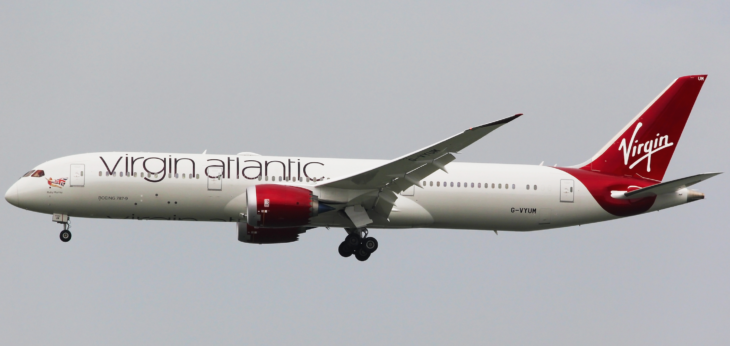 a white airplane with red and black text