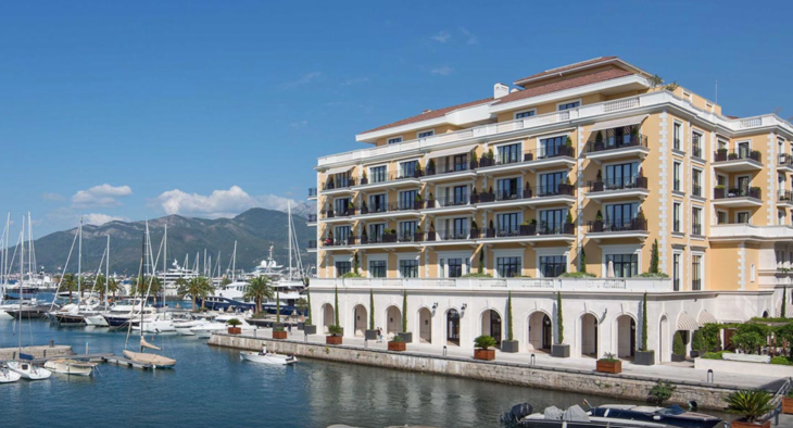 a building with many balconies and a body of water