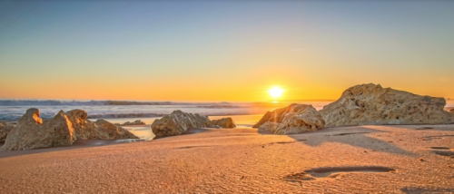 a beach with rocks and waves