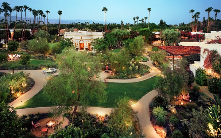 a large garden with a building and trees