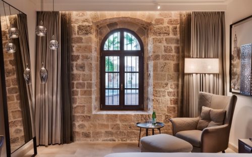 a room with a stone wall and a window