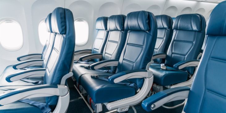 a row of blue seats in an airplane