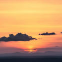 a sunset over a mountain range