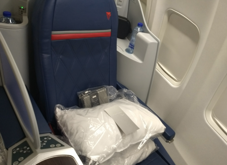 a seat with a bag of white pillows and a plastic bag on it