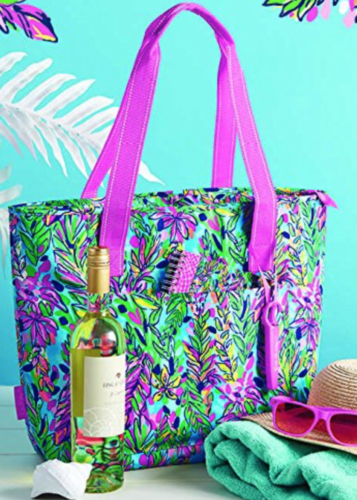 a colorful bag with a bottle of wine and sunglasses