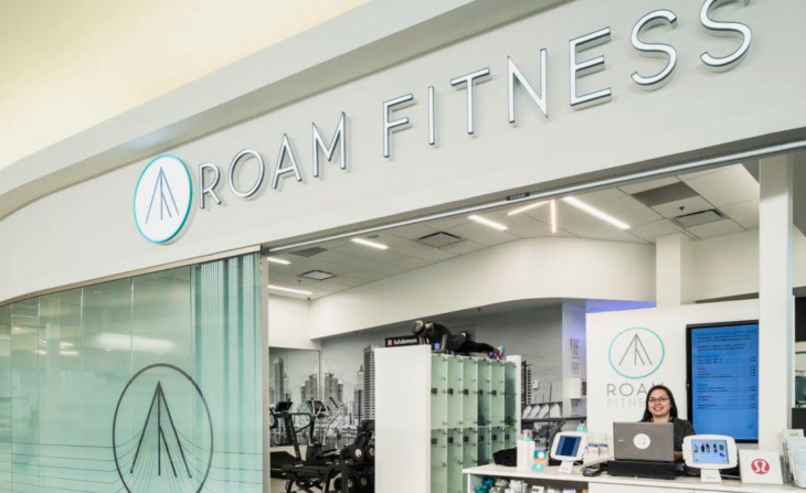 a gym with a sign and exercise equipment