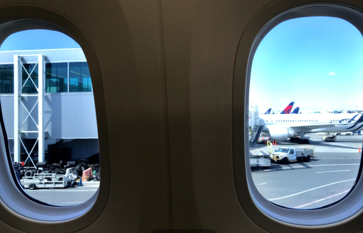 two windows with a plane in the background