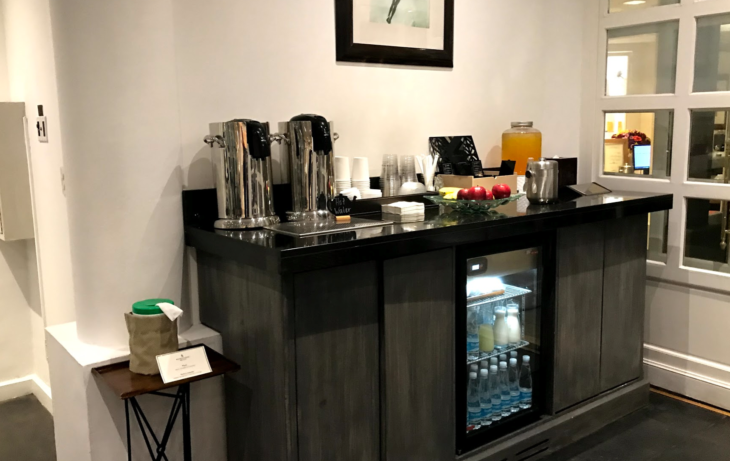 a counter with a beverage cooler and a picture on the wall