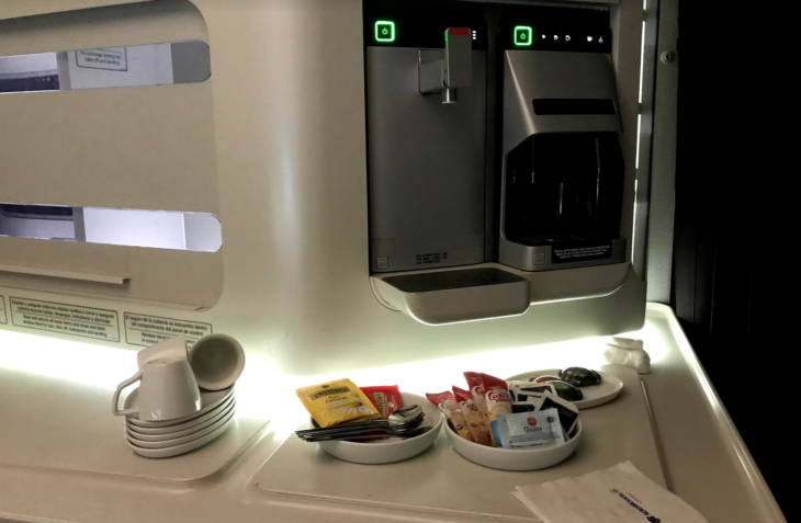 a machine with a bowl of food and saucers