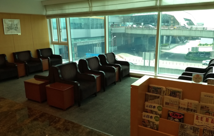 a room with chairs and a bookcase