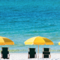 a group of chairs and umbrellas on a beach