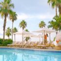 a woman standing near a pool