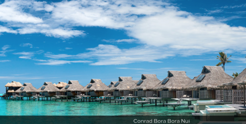 a row of huts on stilts in the water