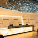 a marble reception desk with lights