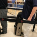 a man standing next to a luggage bag