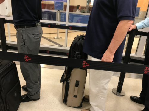 a man standing next to a luggage bag