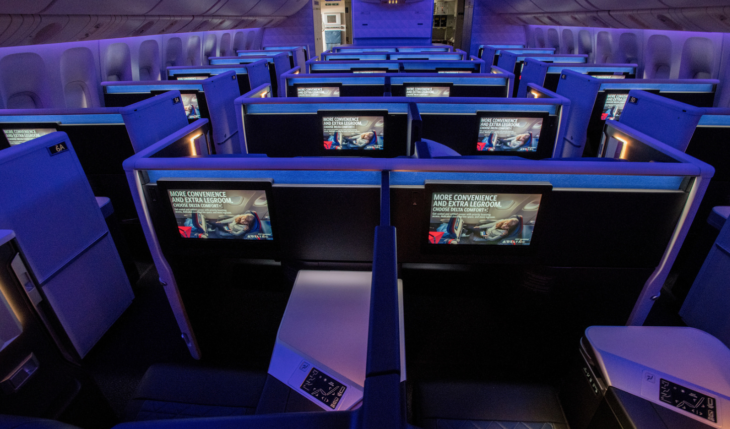 a row of monitors in an airplane