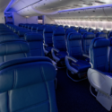 the inside of an airplane with blue seats