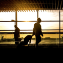 people walking with luggage in an airport