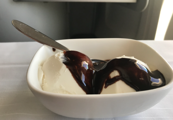 a bowl of ice cream with chocolate sauce