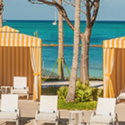 a group of chairs and a tent on a beach