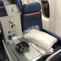 a seat with a bag and a bottle on it