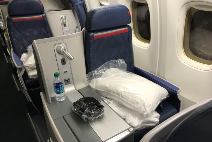 a seat with a bag and a bottle on it