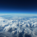 aerial view of snowy mountains and clouds