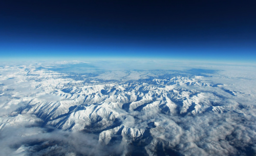 aerial view of snowy mountains and clouds
