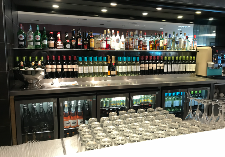 a shelf of liquor bottles and glasses