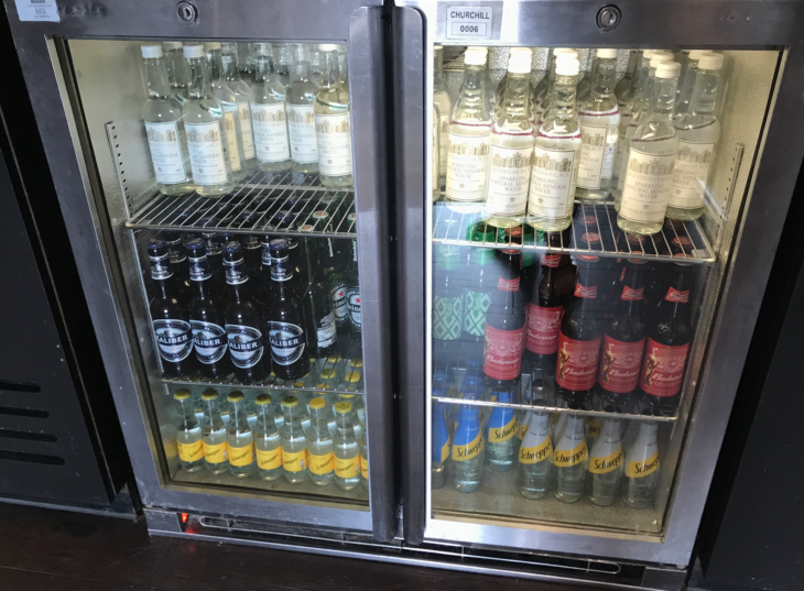 a refrigerator with bottles of alcohol