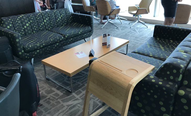 a group of people in a room with a couch and a table