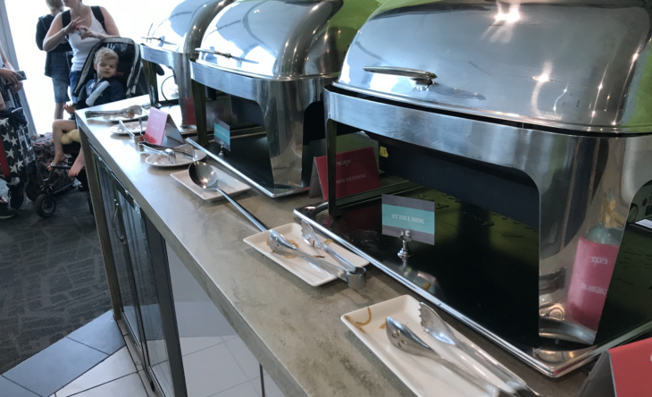 a row of food warmers on a counter