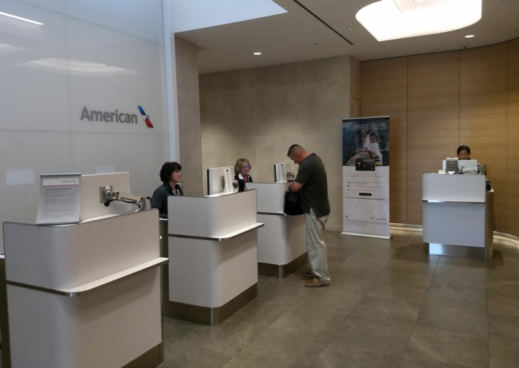 people standing at a counter in a building