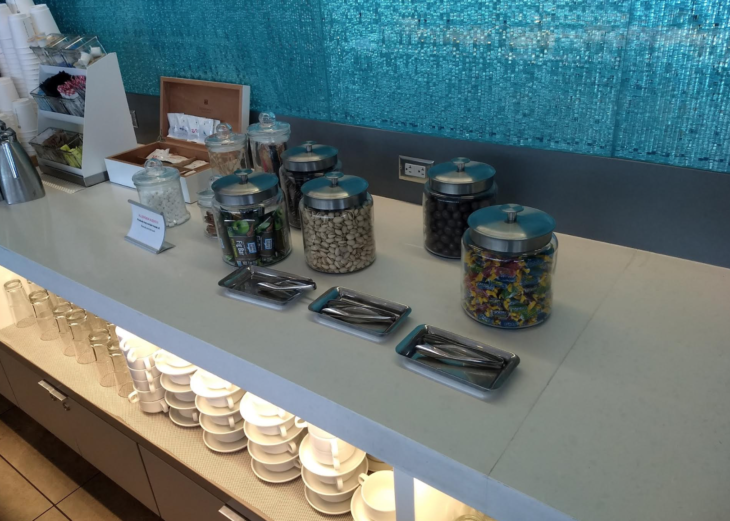 a counter with different types of candy in containers